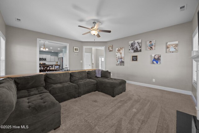 506 White Shoal Way, Sneads Ferry, NC 28460 - carpeted living room with baseboards, visible vents, and ceiling fan with notable chandelier