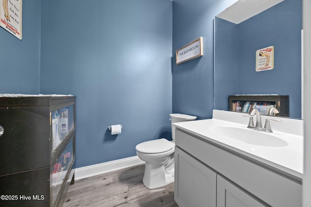 506 White Shoal Way, Sneads Ferry, NC 28460 - bathroom with baseboards, wood finished floors, toilet, and vanity