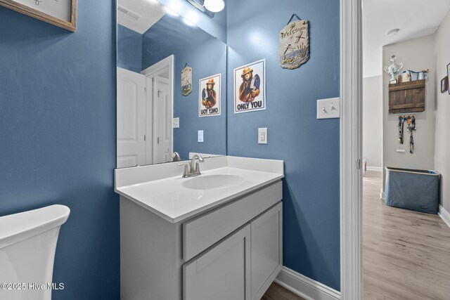 506 White Shoal Way, Sneads Ferry, NC 28460 - bathroom featuring toilet, baseboards, wood finished floors, and vanity