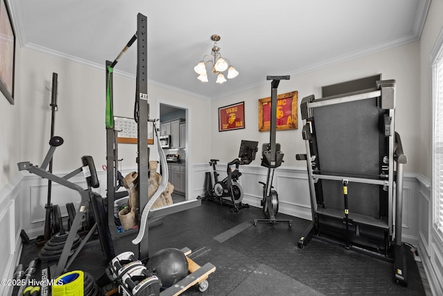 506 White Shoal Way, Sneads Ferry, NC 28460 - exercise area featuring crown molding, wainscoting, a decorative wall, and a notable chandelier