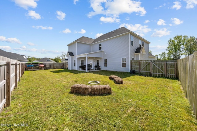 506 White Shoal Way, Sneads Ferry, NC 28460 - rear view of house with a lawn, a patio, and a fenced backyard