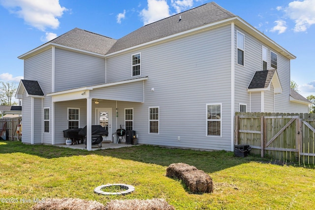 506 White Shoal Way, Sneads Ferry, NC 28460 - rear view of property featuring a lawn, fence, a patio area, and roof with shingles