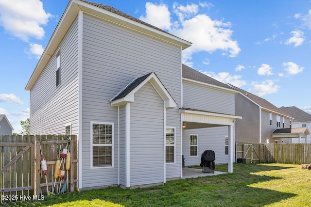506 White Shoal Way, Sneads Ferry, NC 28460 - back of house featuring a fenced backyard, a gate, a patio, and a yard