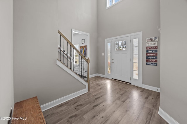 506 White Shoal Way, Sneads Ferry, NC 28460 - entrance foyer featuring baseboards, a high ceiling, stairs, and wood finished floors