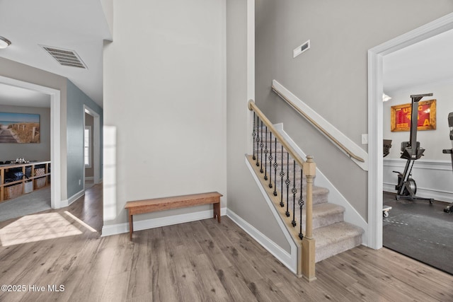 506 White Shoal Way, Sneads Ferry, NC 28460 - stairs with baseboards, wood finished floors, and visible vents