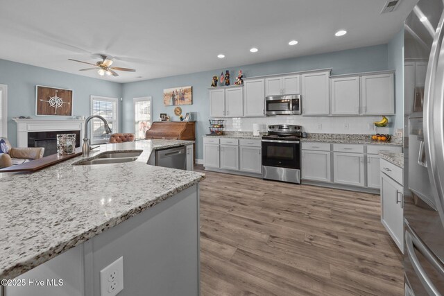 506 White Shoal Way, Sneads Ferry, NC 28460 - kitchen with a ceiling fan, backsplash, visible vents, a sink, and stainless steel appliances