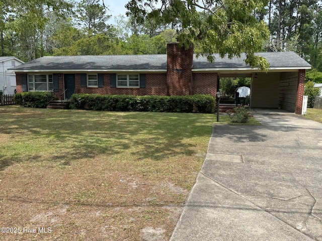 single story home featuring brick siding, driveway, a chimney, and a front yard