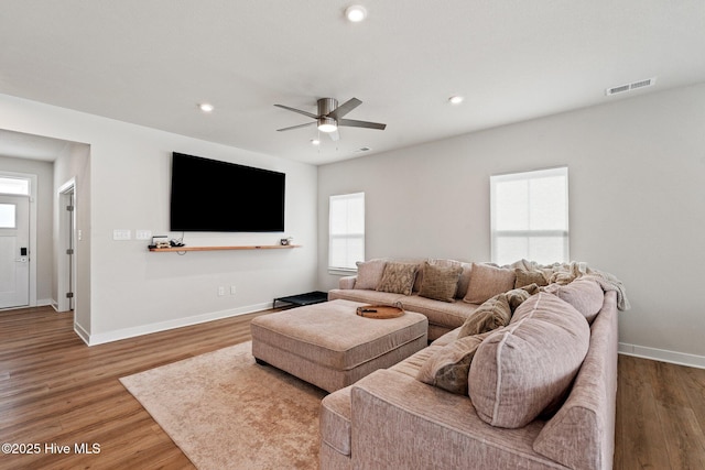 living room with visible vents, baseboards, ceiling fan, recessed lighting, and wood finished floors