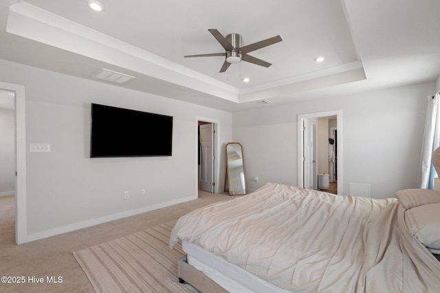 bedroom with a tray ceiling, baseboards, recessed lighting, and light colored carpet