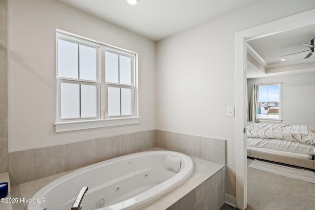 ensuite bathroom with ceiling fan, a jetted tub, and ensuite bath