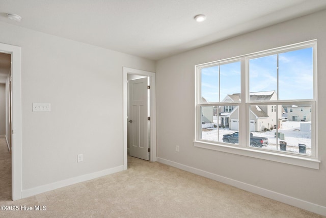 unfurnished bedroom featuring baseboards and carpet flooring