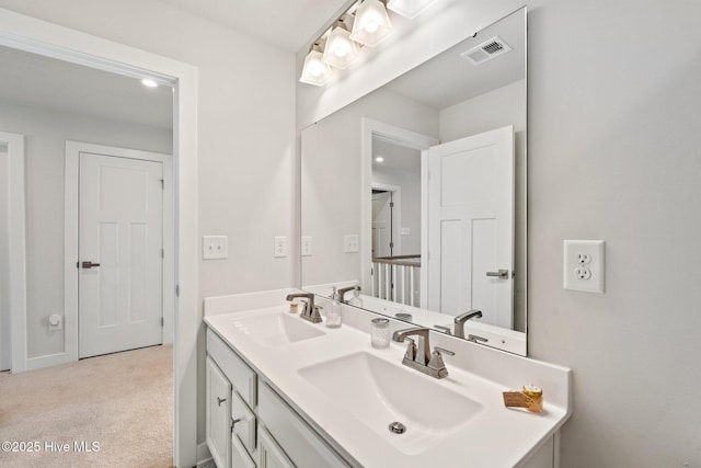bathroom featuring double vanity, a sink, and visible vents