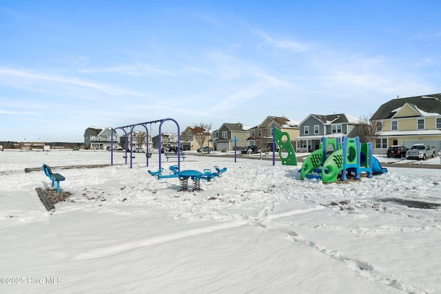 snow covered playground featuring a residential view and playground community