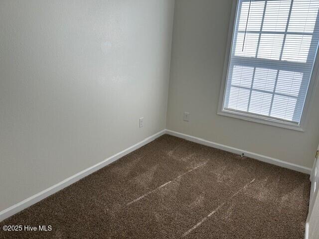 409 E Broad St, Elizabeth City, NC 27909 - unfurnished room with baseboards and carpet flooring