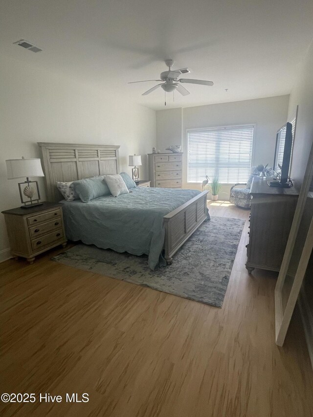 7265 Seashell Ln SW Unit 303, Ocean Isle Beach, NC 28469 - bedroom featuring baseboards, wood finished floors, and a closet