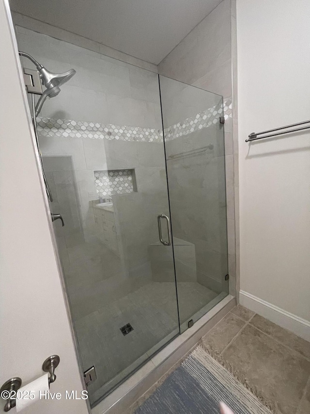 7265 Seashell Ln SW Unit 303, Ocean Isle Beach, NC 28469 - full bathroom with a stall shower, baseboards, and tile patterned floors