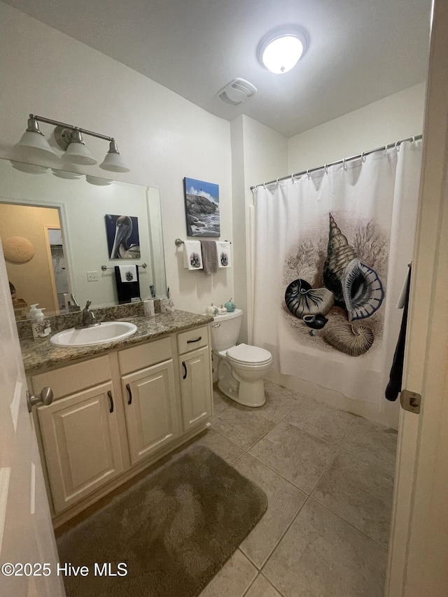 7265 Seashell Ln SW Unit 303, Ocean Isle Beach, NC 28469 - bathroom featuring toilet, tile patterned floors, vanity, and a shower with shower curtain