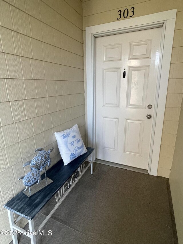 7265 Seashell Ln SW Unit 303, Ocean Isle Beach, NC 28469 - kitchen featuring a sink, stainless steel dishwasher, light stone countertops, light tile patterned floors, and crown molding