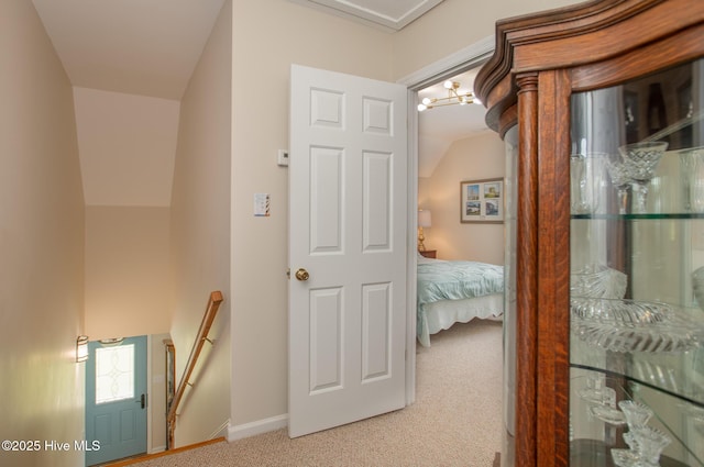 101 Beaufort Walk, Beaufort, NC 28516 - corridor with baseboards, an inviting chandelier, an upstairs landing, lofted ceiling, and carpet