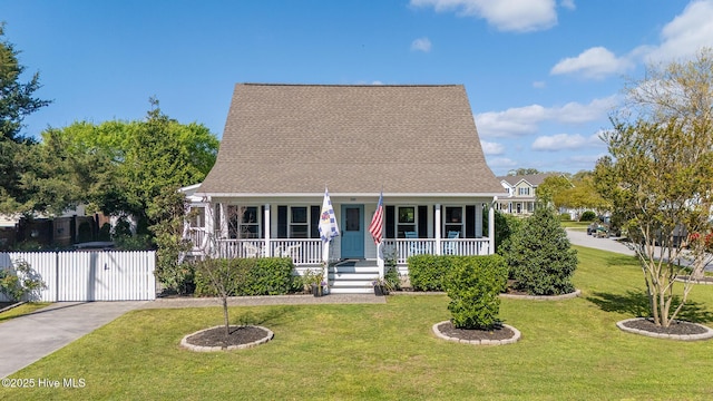 101 Beaufort Walk, Beaufort, NC 28516 - cape cod house with covered porch, fence, a front lawn, and a gate