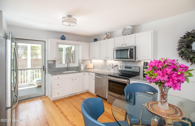 101 Beaufort Walk, Beaufort, NC 28516 - kitchen with tasteful backsplash, white cabinets, light stone countertops, stainless steel appliances, and a sink
