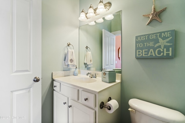 bathroom featuring toilet and vanity