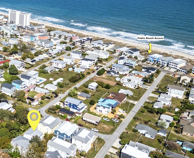 aerial view with a beach view, a water view, and a residential view