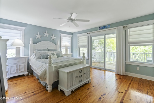 bedroom with light wood-type flooring, access to exterior, and multiple windows