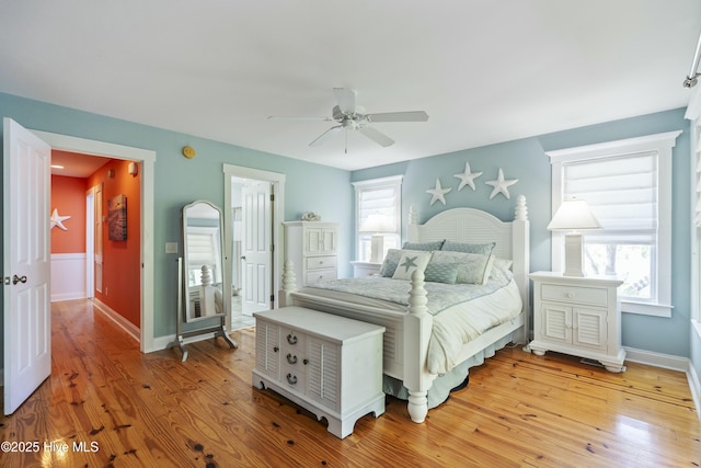 bedroom with light wood-type flooring, a ceiling fan, and baseboards