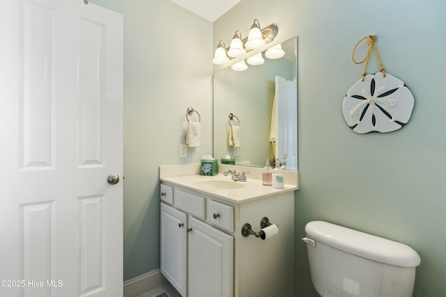 bathroom featuring toilet and vanity