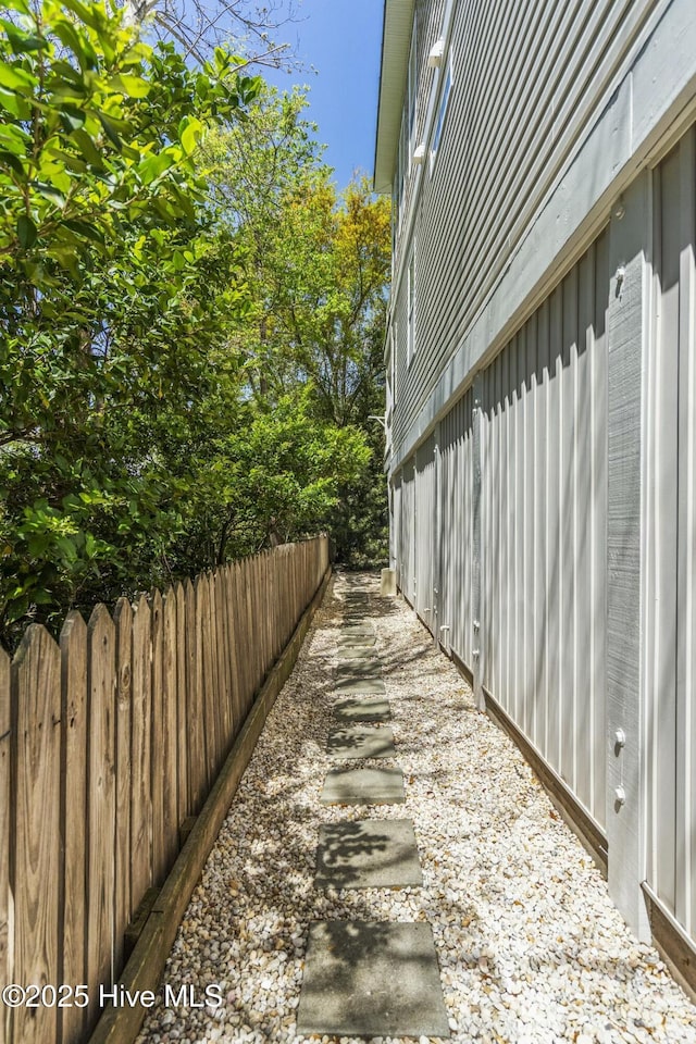 view of side of property featuring fence