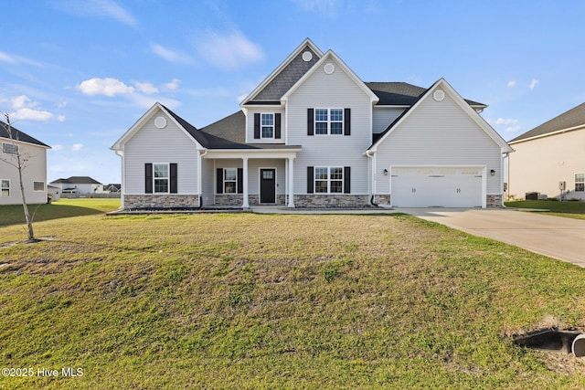 view of front of home with a front lawn, stone siding, a garage, and concrete driveway