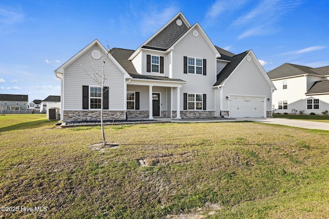 view of front of house with concrete driveway, stone siding, a front yard, a porch, and central AC unit