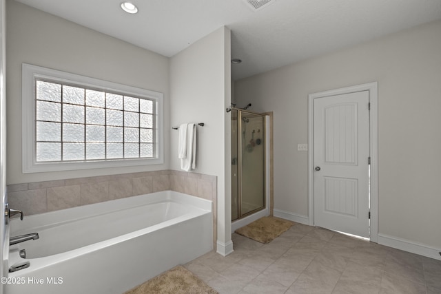 full bathroom with a bath, a stall shower, and baseboards