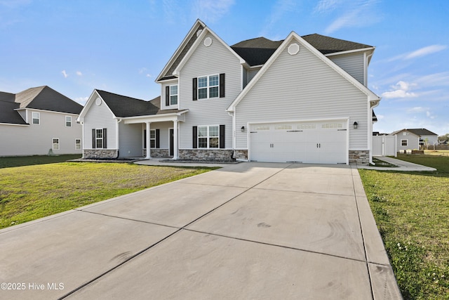 traditional-style house featuring a front yard, stone siding, and concrete driveway