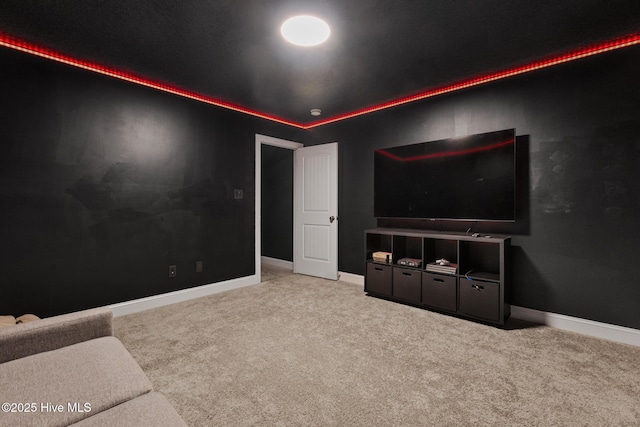 cinema room featuring carpet flooring and baseboards