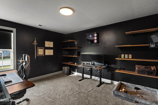 office area with visible vents, baseboards, carpet, and a textured ceiling