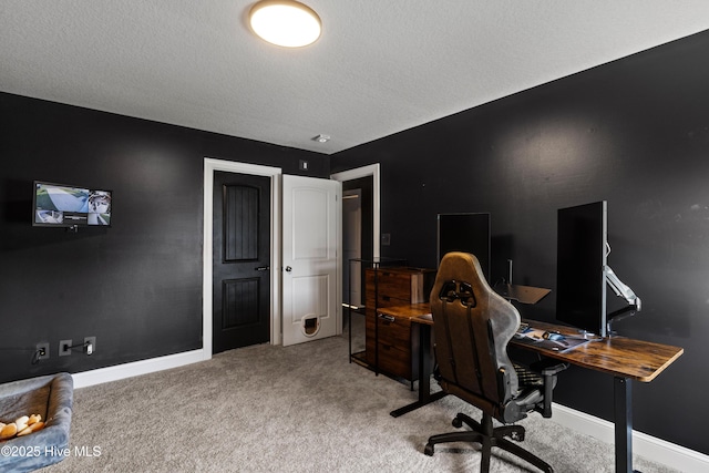 office with baseboards, light colored carpet, and a textured ceiling