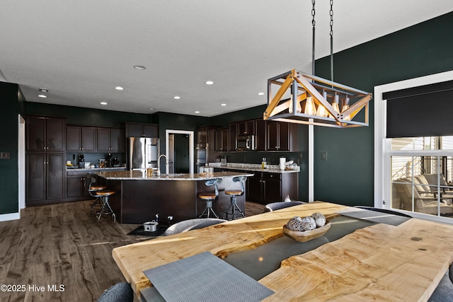 dining space with recessed lighting, baseboards, and dark wood finished floors