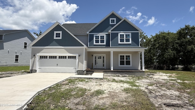 295 E Ivybridge Dr, Hubert, NC 28539 - view of front of house featuring a porch, concrete driveway, and a garage