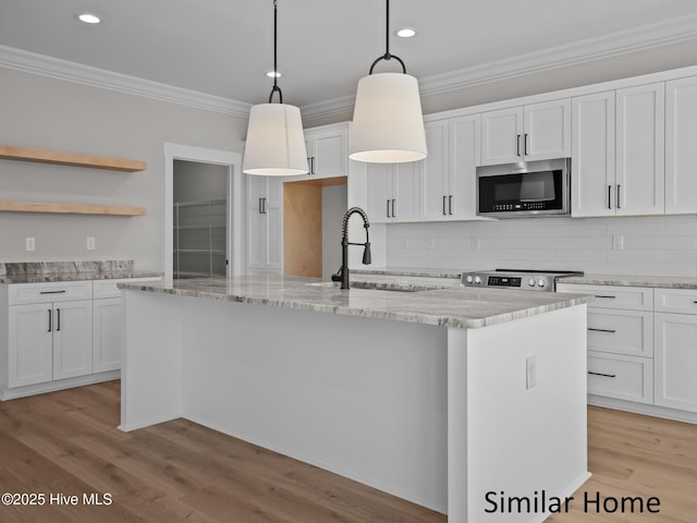 295 E Ivybridge Dr, Hubert, NC 28539 - kitchen featuring appliances with stainless steel finishes, crown molding, a center island with sink, backsplash, and white cabinetry