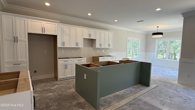 295 E Ivybridge Dr, Hubert, NC 28539 - kitchen featuring a kitchen island, white cabinets, crown molding, wainscoting, and decorative light fixtures