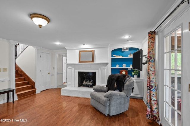 379 Greenbrier Rd, Tarboro, NC 27886 - living area featuring ornamental molding, a fireplace, wood finished floors, and stairs