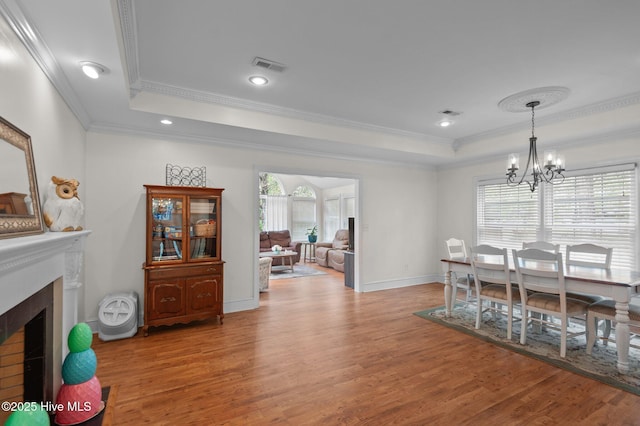 379 Greenbrier Rd, Tarboro, NC 27886 - dining room with ornamental molding, light wood-style flooring, and a raised ceiling