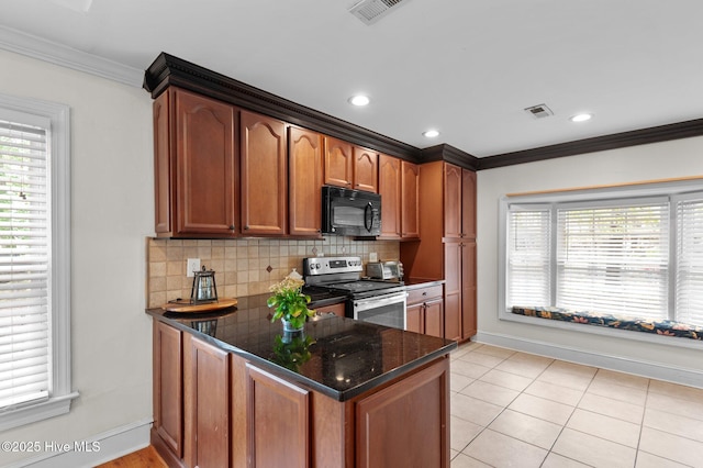 379 Greenbrier Rd, Tarboro, NC 27886 - kitchen with stainless steel electric stove, black microwave, ornamental molding, visible vents, and a healthy amount of sunlight