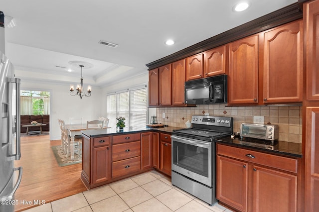 379 Greenbrier Rd, Tarboro, NC 27886 - kitchen featuring tasteful backsplash, a peninsula, crown molding, visible vents, and appliances with stainless steel finishes
