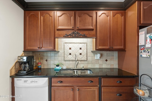 379 Greenbrier Rd, Tarboro, NC 27886 - kitchen featuring a sink, backsplash, freestanding refrigerator, and white dishwasher