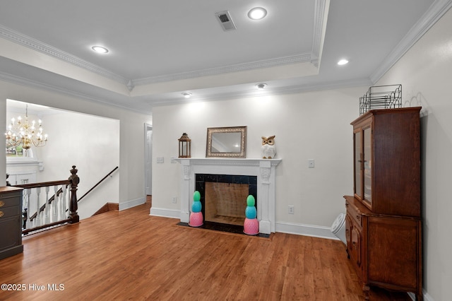 379 Greenbrier Rd, Tarboro, NC 27886 - unfurnished living room featuring visible vents, a tiled fireplace, ornamental molding, recessed lighting, and wood finished floors