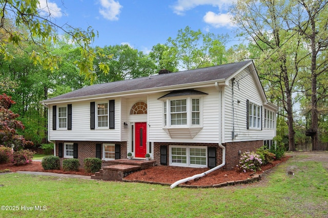 379 Greenbrier Rd, Tarboro, NC 27886 - split foyer home with a chimney, a front yard, and brick siding
