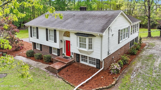 379 Greenbrier Rd, Tarboro, NC 27886 - raised ranch featuring central AC, a chimney, a shingled roof, and brick siding